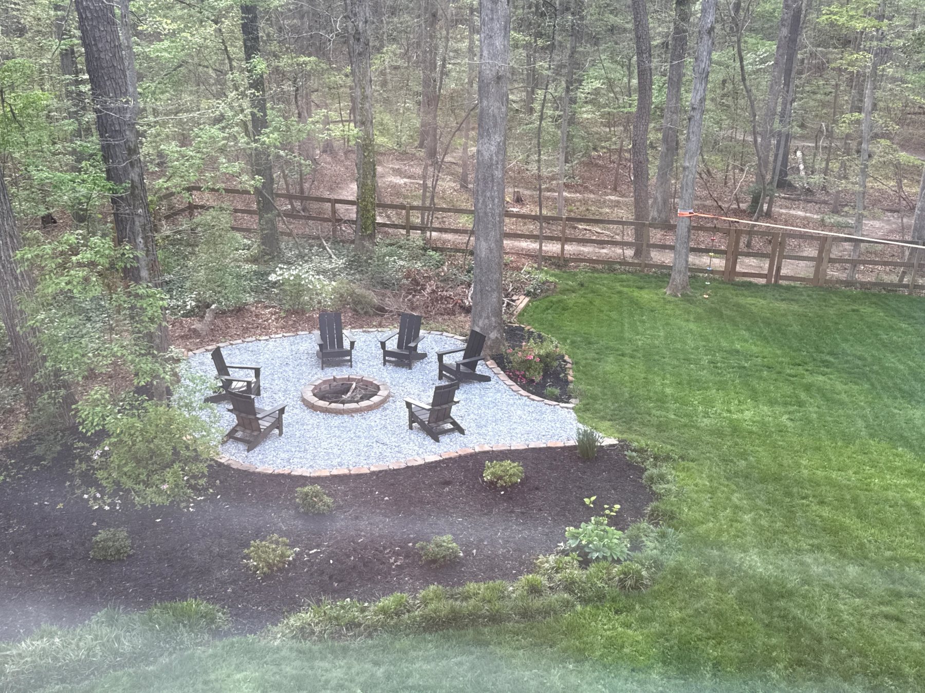 Finished backyard landscaping with fire pit and lawn